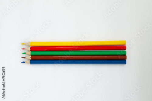 Sharpened colored pencils isolated on a white background. Office supplies