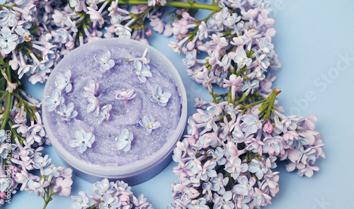  scrub with a lilac petals on background with a copy space.