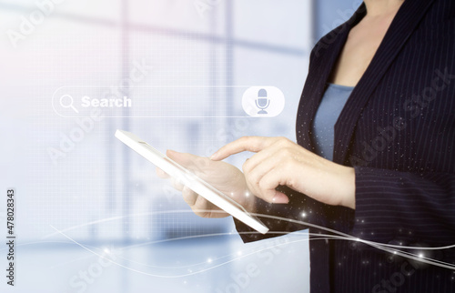 Searching Internet Data. Web Browsing Concept. Hand touch white tablet with digital hologram search data sign on light blurred background. Searching information data on internet networking. photo