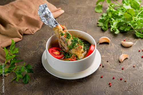 Khashlama with lamb on bowl on brown table photo