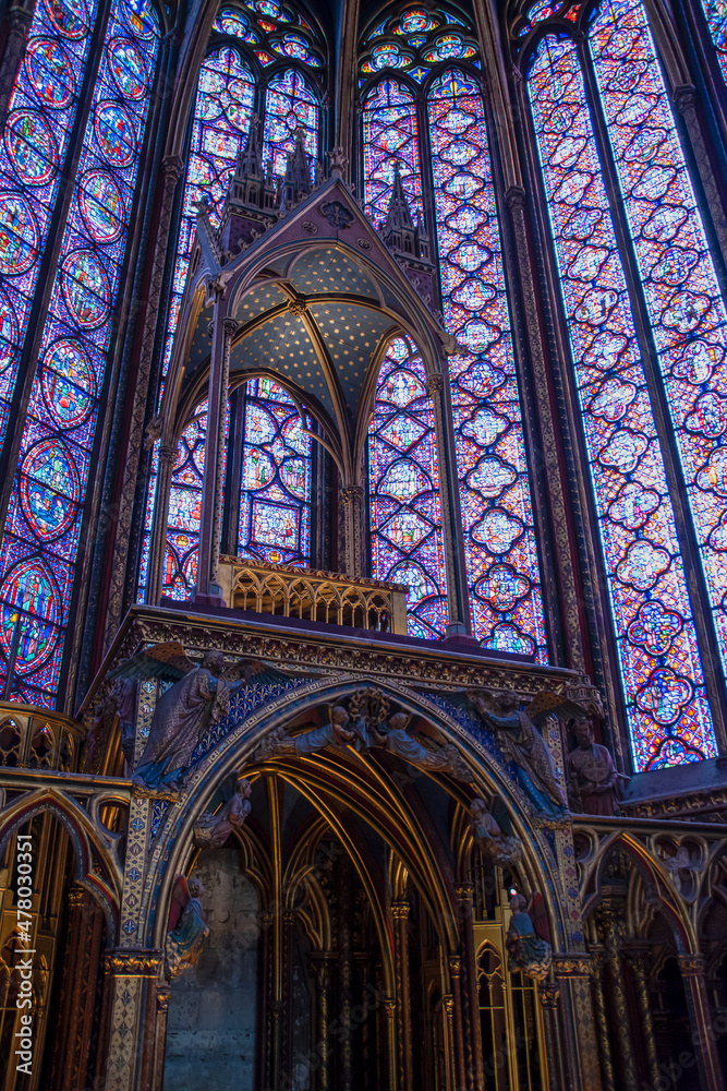 A view looking up at some stained glass windows in the medieval church Saint Chapel in Paris, France.