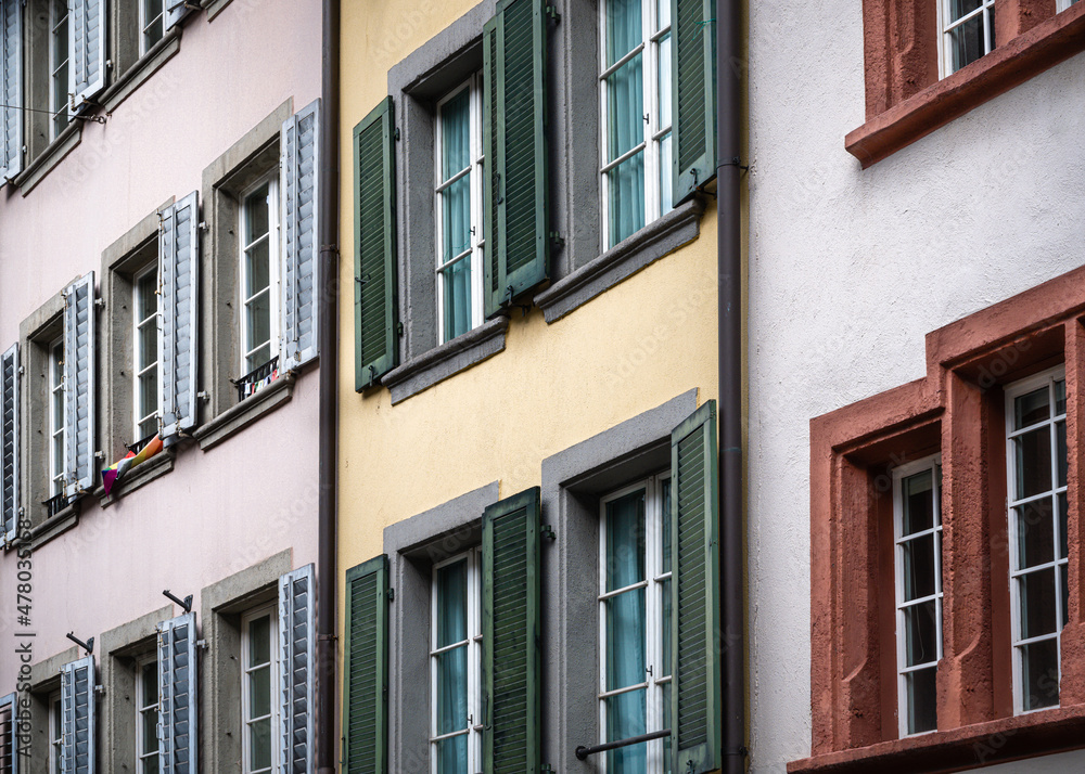 Rows of multicolored shuttered windows 