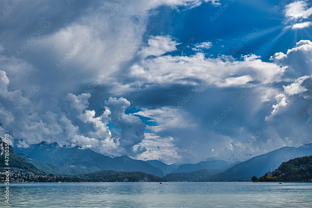 lake annecy with mountains and clouds
