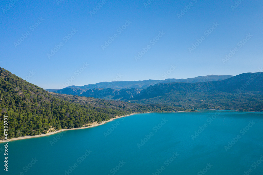 The Lac de Sainte-Croix surrounded by the impressive mountains in Europe, in France, Provence Alpes Cote dAzur, in the Var, in summer, on a sunny day.