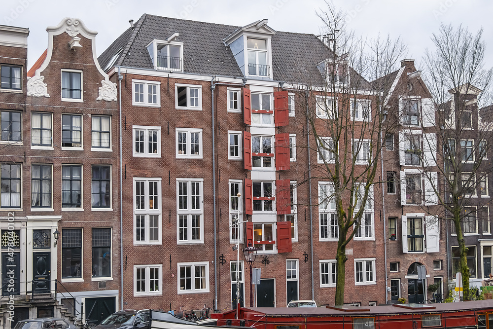 Row of ancient traditional Dutch townhouses at Prinsengracht canal in Amsterdam. Prinsengracht (Prince's Canal) named after the Prince of Orange. Amsterdam, the Netherlands.