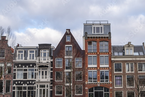 Row of ancient traditional Dutch townhouses (XVI- XVIII centuries) at Prinsengracht canal in Amsterdam. Prinsengracht (Prince's Canal) named after the Prince of Orange. Amsterdam, the Netherlands.