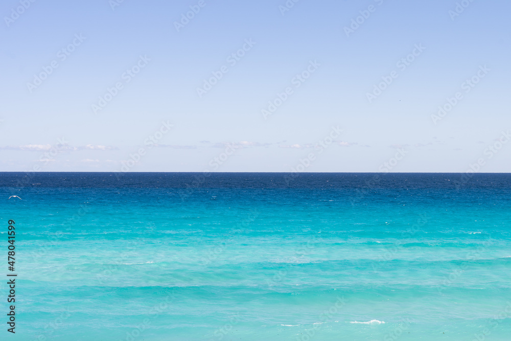 Touristic caribbean beach in Mexico with vivid blue spectrum
