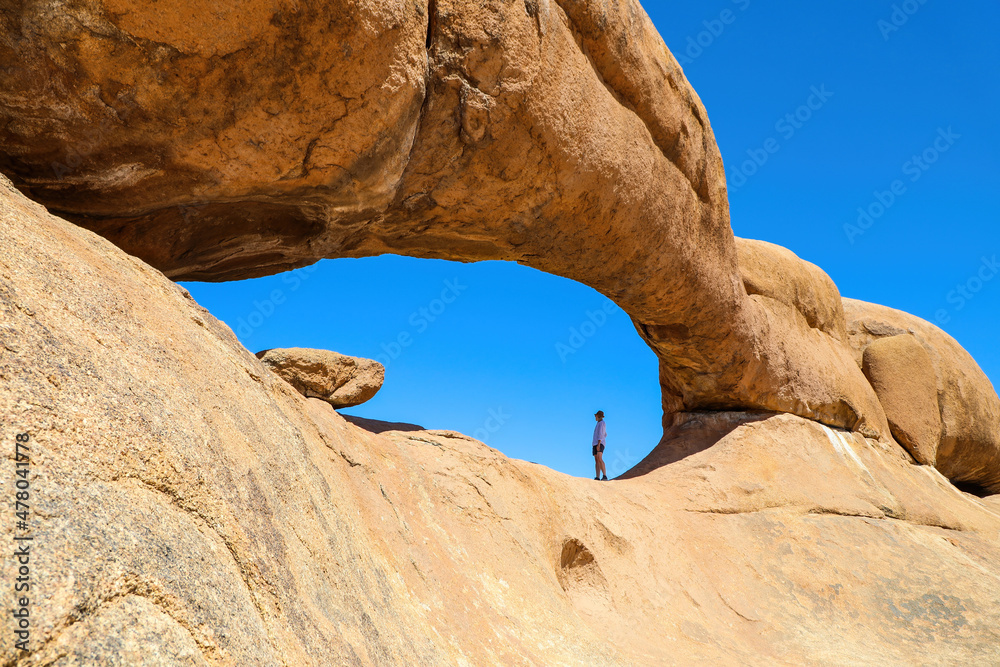 Woman hiker enjoying the rock arches of Spitzkoppe Namibia Woman hiker enjoying the rock arches of Spitzkoppe Namibia