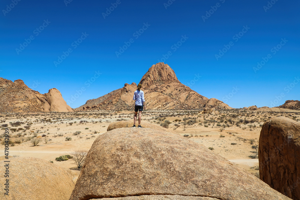 Woman hiker enjoying the rock landscapes Spitzkoppe Namibia
