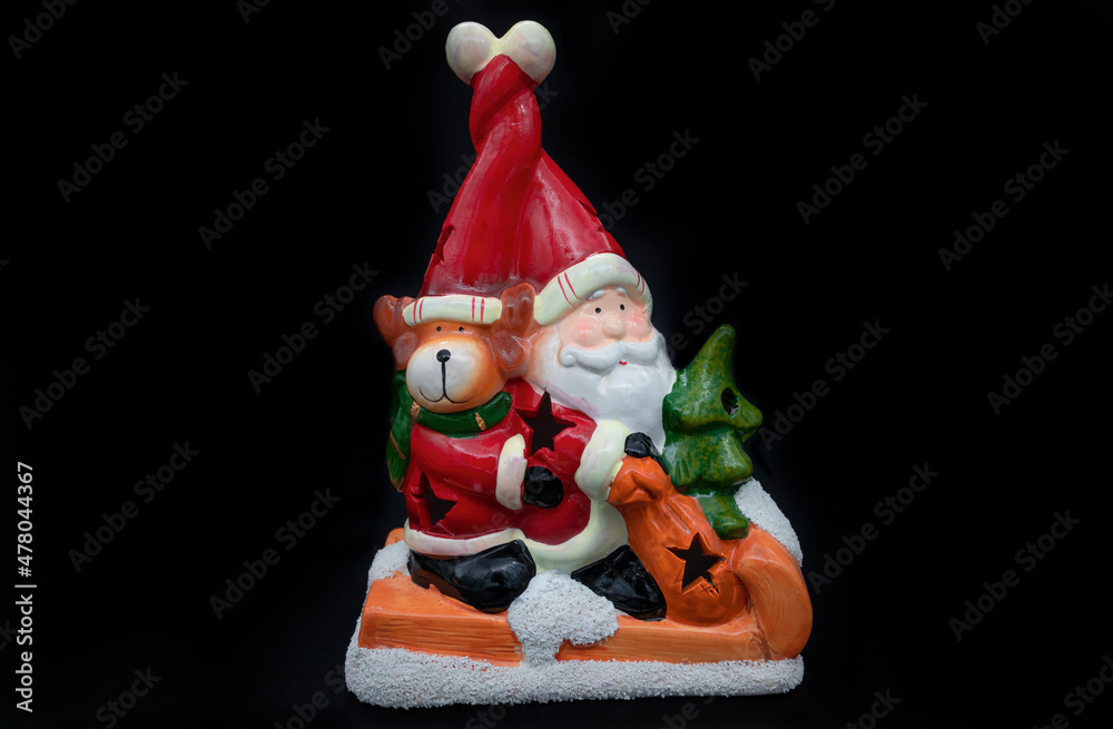 Santa Claus with his reindeer isolated on a black background Santa Claus with his reindeer isolated on a black background
