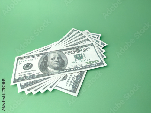 Dollar banknotes on a green background with copy space. Business concept.