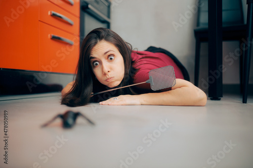 Woman Following a Big Insect on the Kitchen Floor 