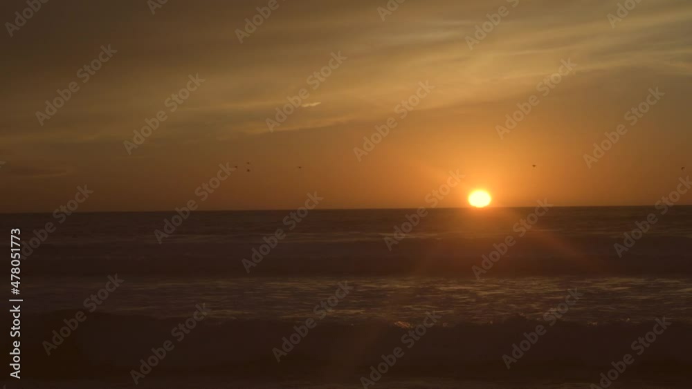 This time lapse video shows a beautiful glowing sunset over ocean waves. This time lapse video shows a beautiful glowing sunset over ocean waves.