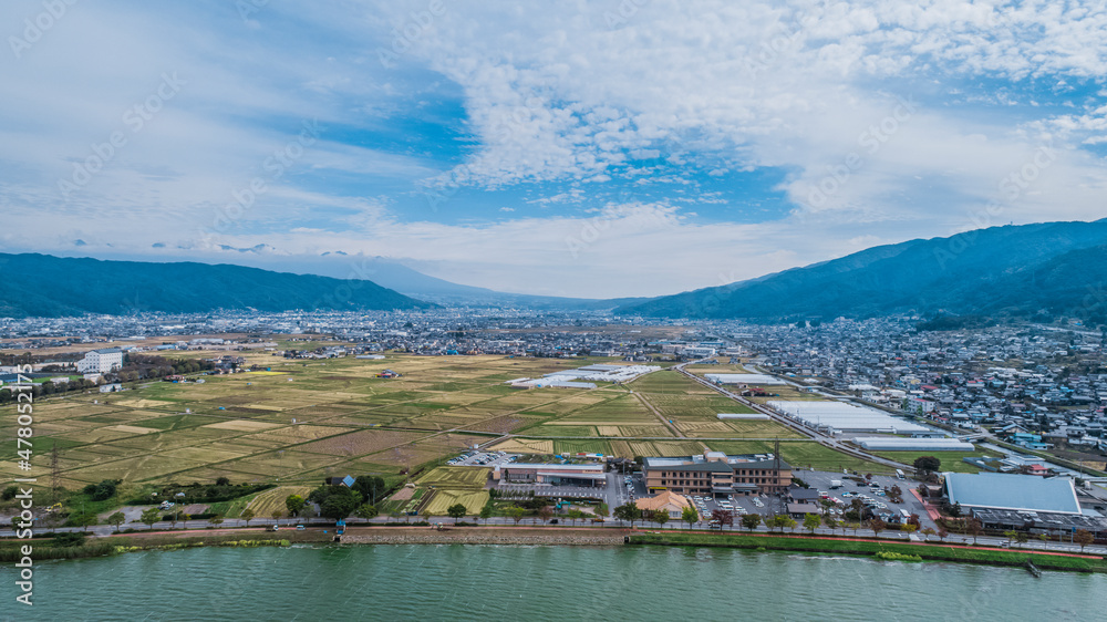 Drone shot of Lake Suwa & Kiso Mountains. Nagano Japan