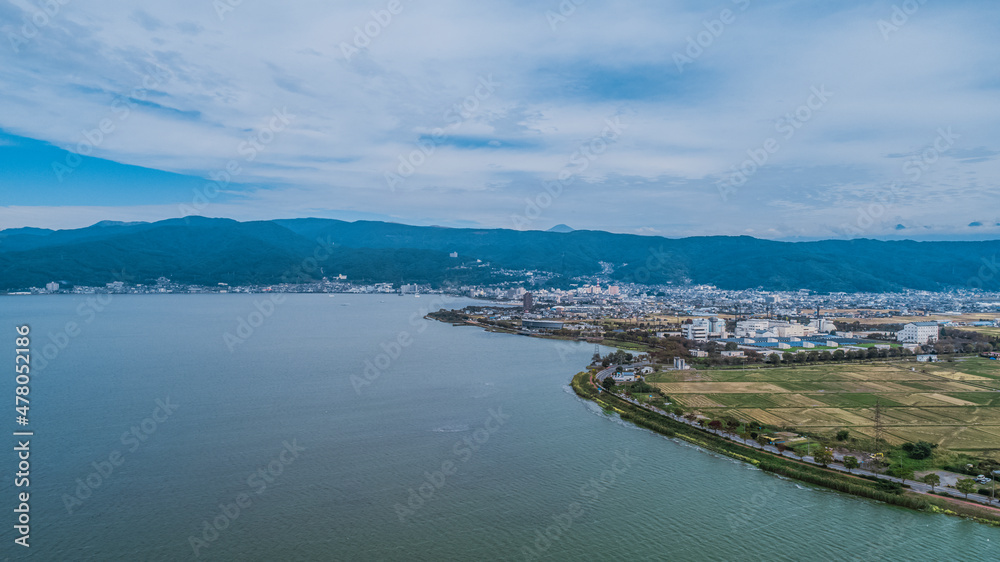 Drone shot of Lake Suwa & Kiso Mountains. Nagano Japan