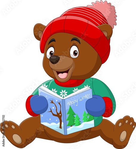 Cartoon little bear in winter clothes reading a book