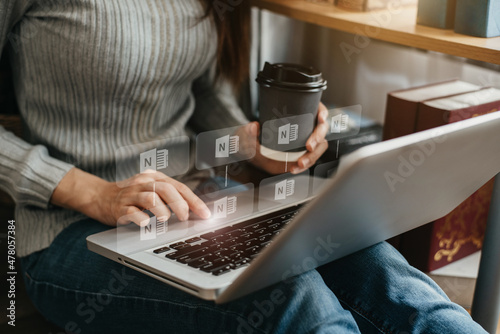 Woman uses a laptop to search for information in the home in the morning. photo