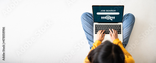 Top view of woman sitting on floor and using laptop job search. Online recruitment career business company concept. Panoramic image with empty copy space