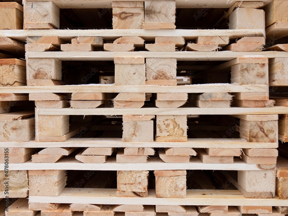 The pallets are located in a stack in the warehouse. The pallets are located in a stack in the warehouse.