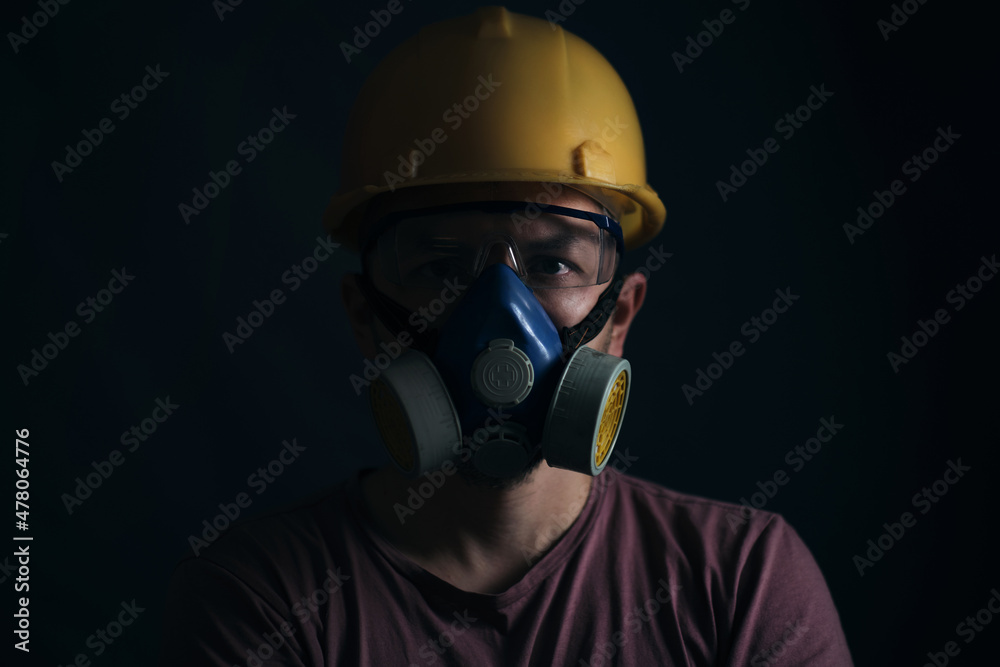 Portrait miner in helmet, respirator and goggles. Portrait miner in helmet, respirator and goggles.