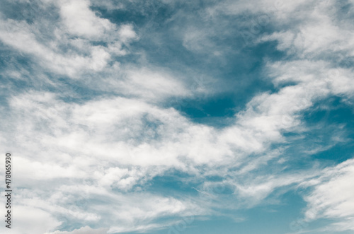 A drawing of white clouds in a blue sky.