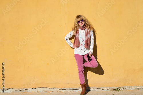 woman with mobile phone on the street wall with space