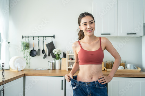 Asian beautiful woman feel happy after lose weight for health in house