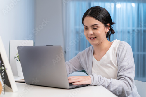 Asian young woman study virtual online and work in living room at home