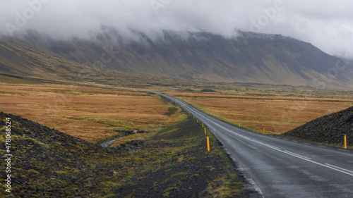 Scenic road through Snæfellsjokull National Park and Snæfellsjokull peak with cloud cover photo