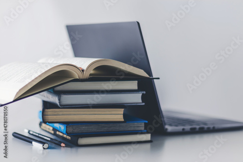 Computer laptop with book. Business success idea and studying concept