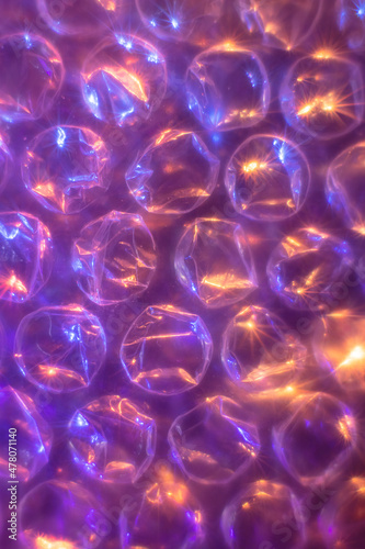 Abstract background with bubble wrap plastic film with soft focus color light.