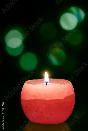 Single candle defocused spots at christmas