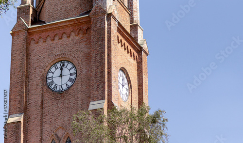 Twelve o'clock on clock bricked tower of Fredrikstad Cathedral in Norway photo