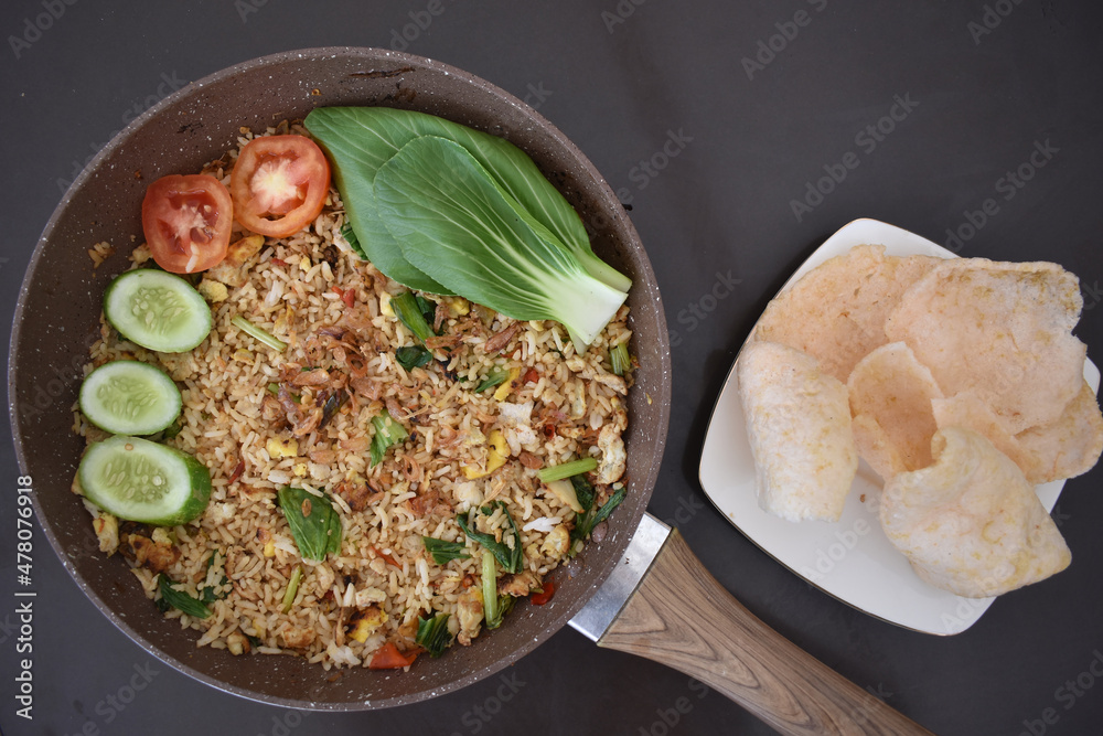 Very Delicious Fried Rice on A Teflon Serving With Crispy Crackers for Dinner