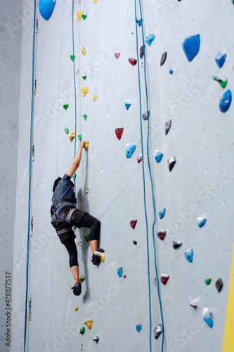 climbing wall background. person climbing on wall