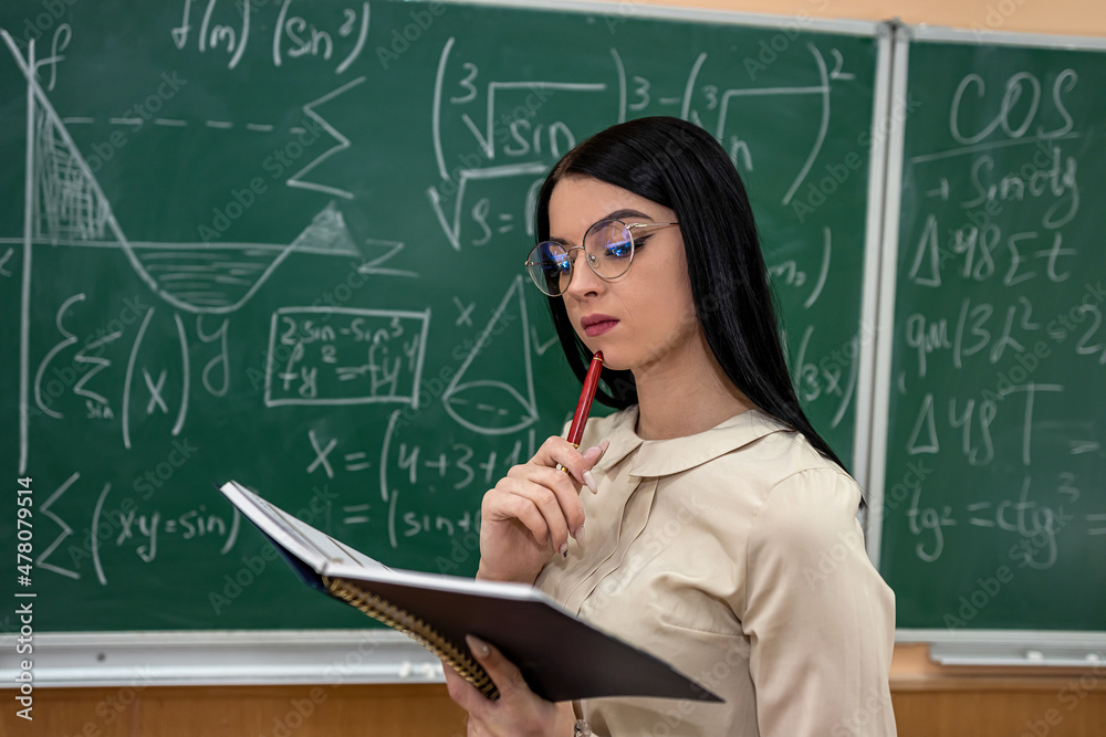 portrait female teacher or a student against blackboard and explain a lesson