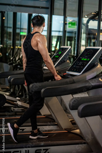 Asian men wear black workout in fitness center © Sommart Sopon