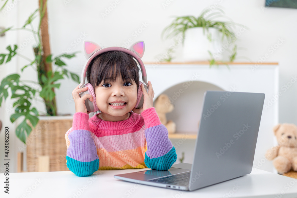 Asian girl using Laptop computer for online study homeschooling during home quarantine. homeschooling, online study, home quarantine, online learning, corona virus or education technology concept Asian girl using Laptop computer for online study homeschooling during home quarantine. homeschooling, online study, home quarantine, online learning, corona virus or education technology concept