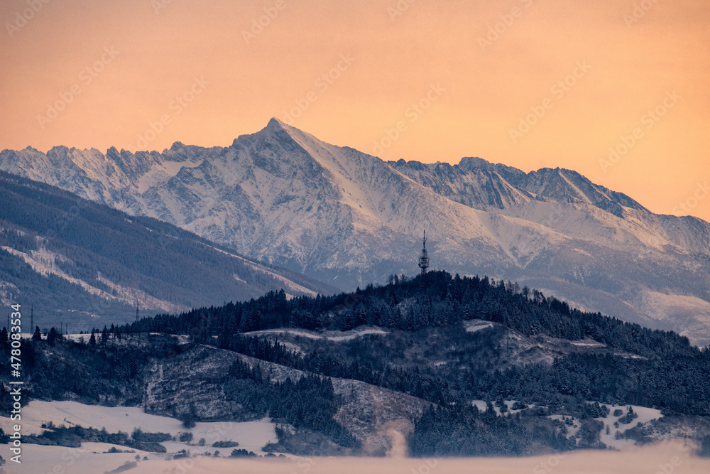 Beautiful winter snowy peak Krivan in High Tatras mountains at Slovakia. Colorful beautiful sky due sunrise.