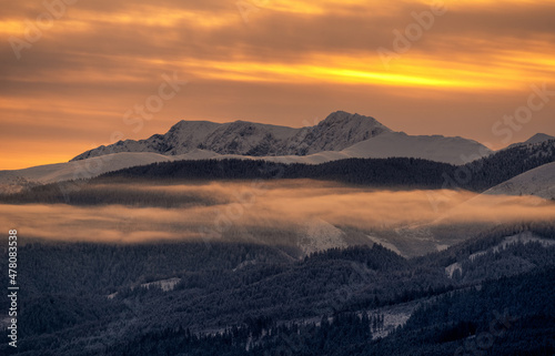 Snowy winter mountain landscape and colorful sky due sunrise over hill Dumbier in Low Tatras mountains at Slovakia