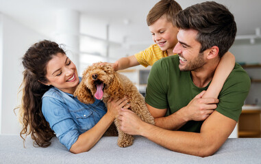 Happy family having fun time, playing together at home with dog