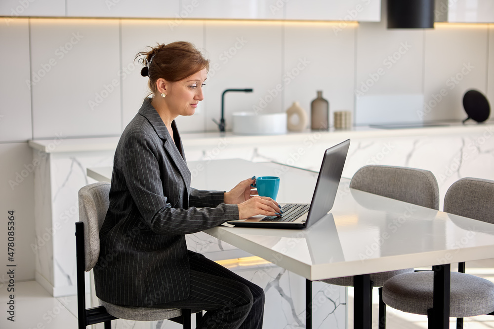 Live streaming virtual classes by woman in business suit with laptop. Live streaming virtual classes by woman in business suit with laptop.