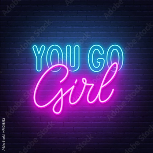 You go girl neon lettering on brick wall background.