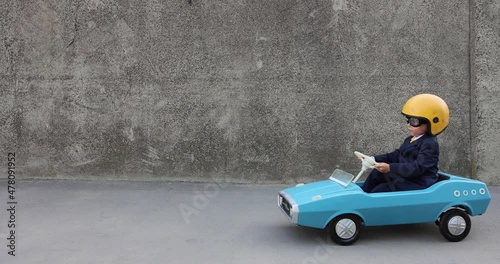 Funny businessman driving retro pedal car outdoor. Slow motion 4K