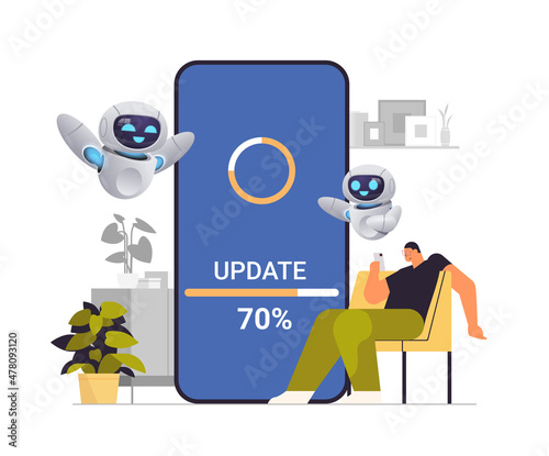 man with robots helpers updating operating system update process install new software on smartphone artificial intelligence