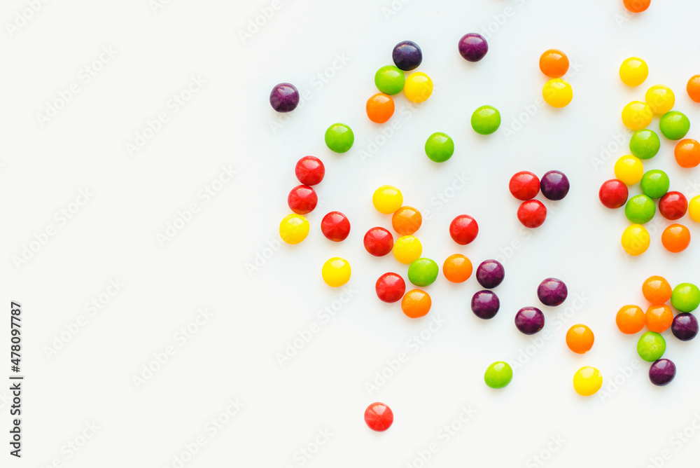 Colored dragee on a white background. Fruit sweets. Bright background. 