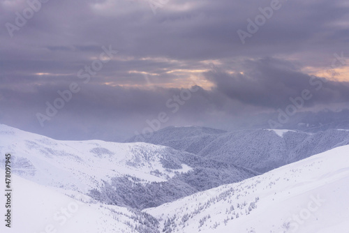 Snow-covered mountain slopes at sunset. Winter landscape. Carpathian Mountains.