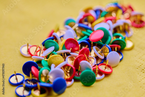 Colorful thumbtacks close up macro shot, shallow depth of field, image for background.