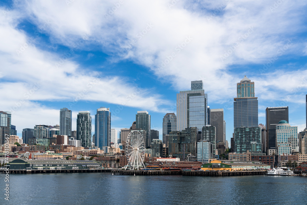 Seattle skyline with waterfront and Great wheel view. Skyscrapers of financial downtown at day time, Washington, USA. A vibrant business neighborhood Seattle skyline with waterfront and Great wheel view. Skyscrapers of financial downtown at day time, Washington, USA. A vibrant business neighborhood
