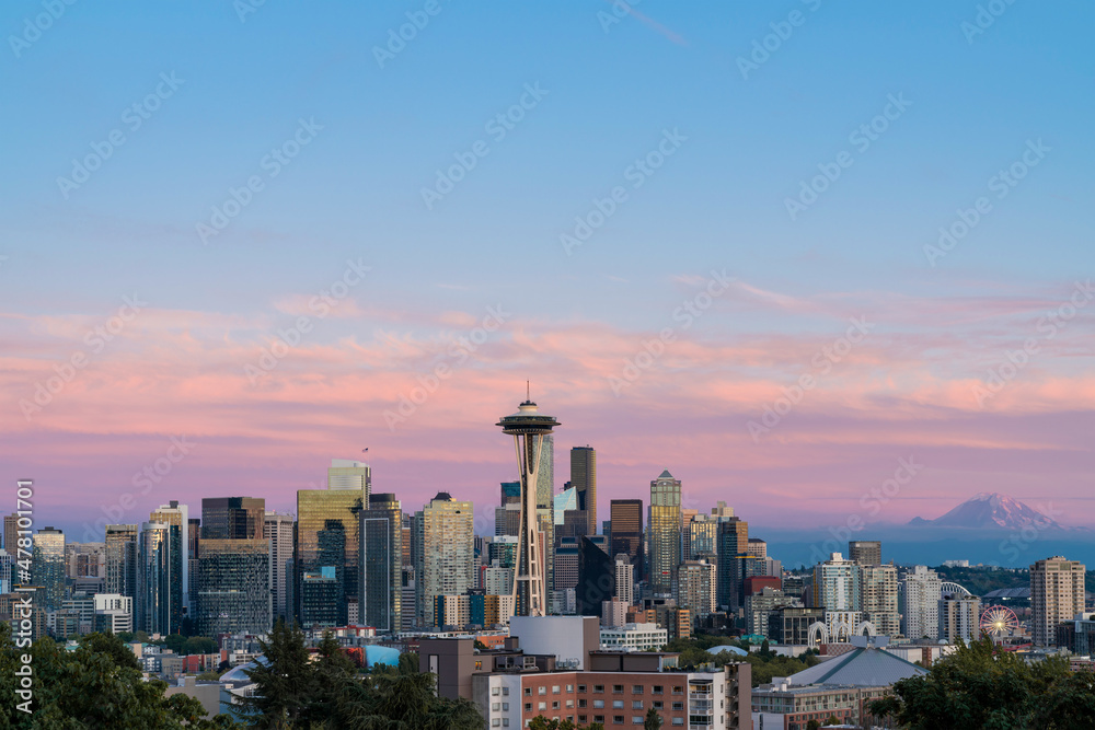 Seattle skyline panorama with iconic view observation tower called Space Needle as seen from Kerry Park. Skyscrapers of financial downtown at sunset, Washington, USA. A vibrant business neighborhood